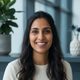 Portrait of a diverse woman smiling, conveying trust and happiness.